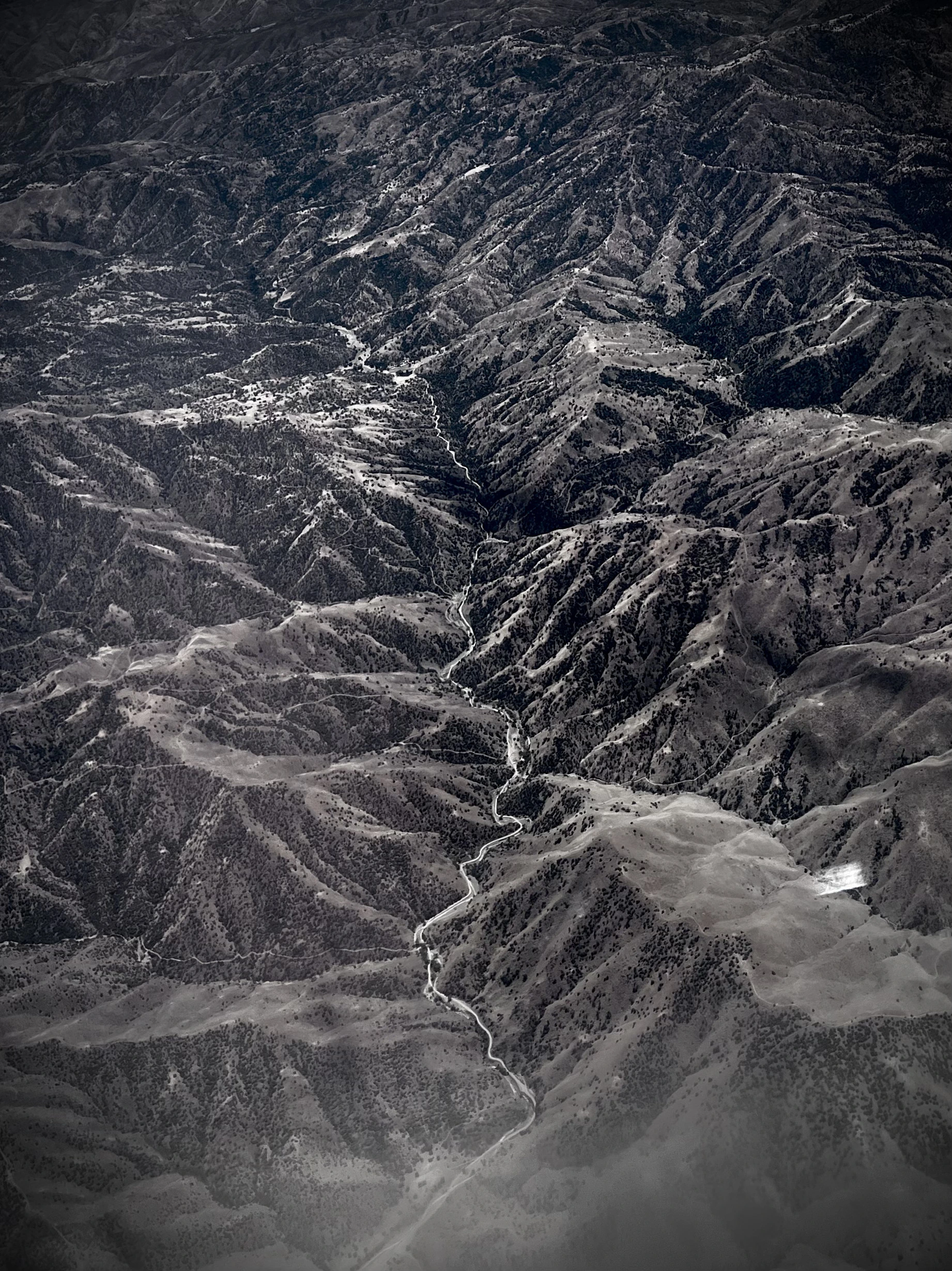 Dramatic shot of Sierra Nevada Mt. Range from airplane, by Tina Xing photography